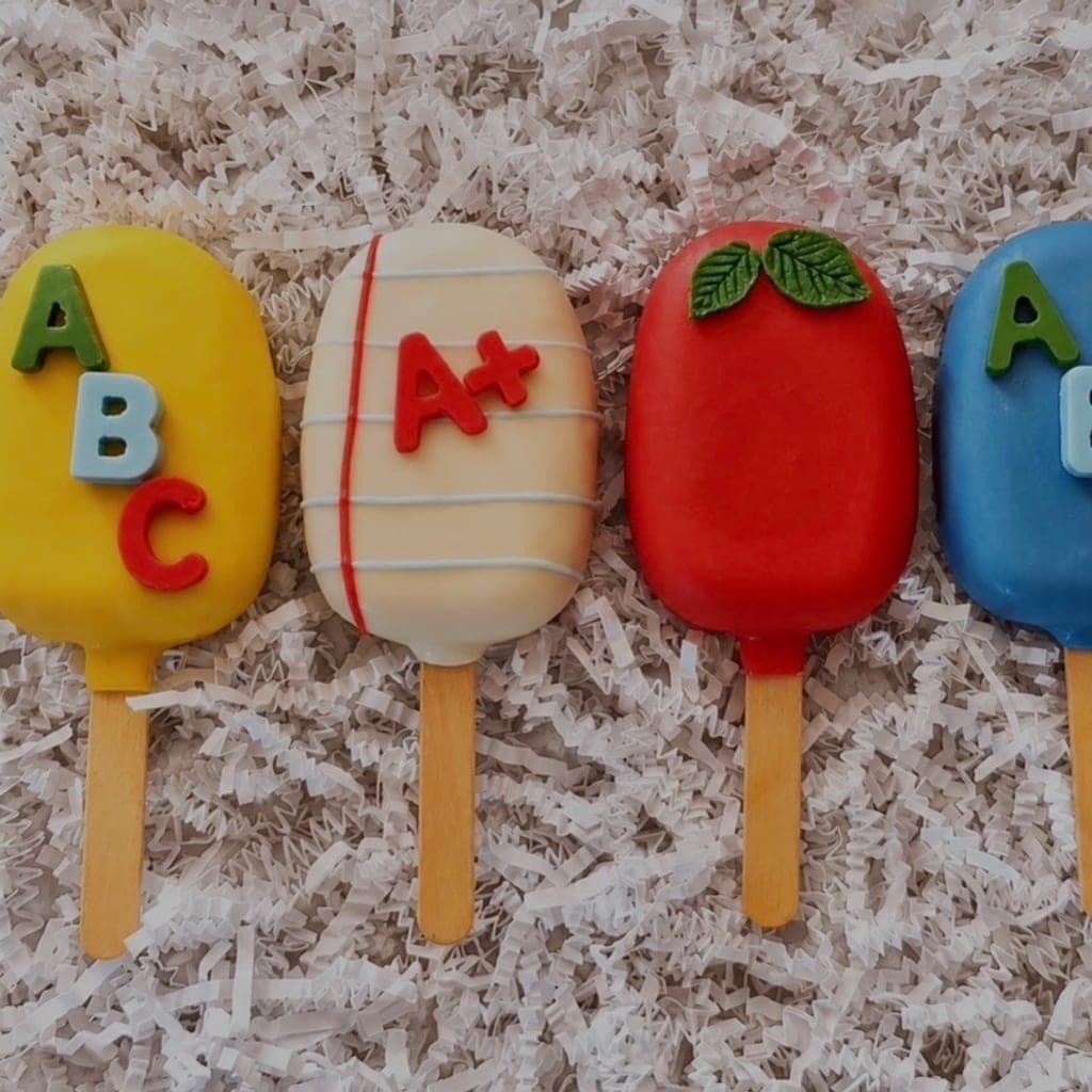 Playful back-to-school themed cakesicles — ABC, A+, and apple designs