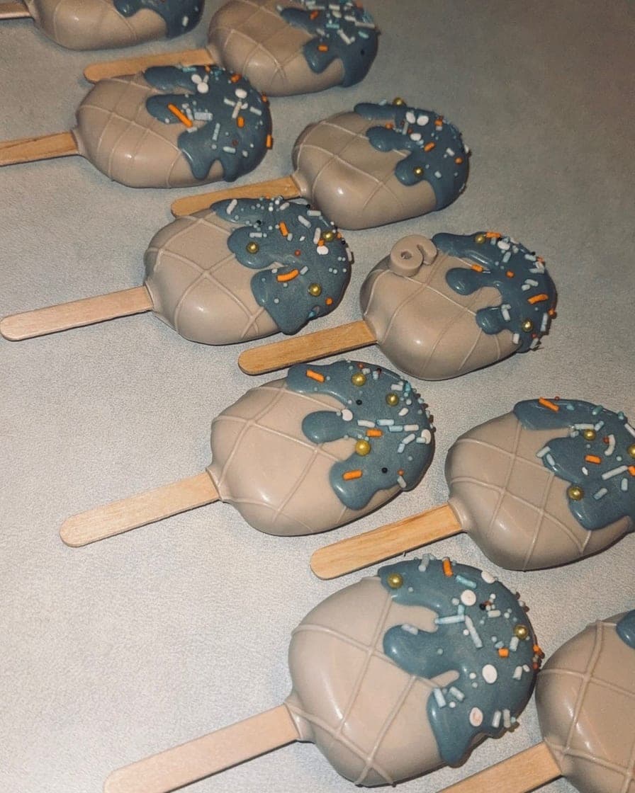 Cakesicles with soft blue drizzle and gold pearl sprinkles